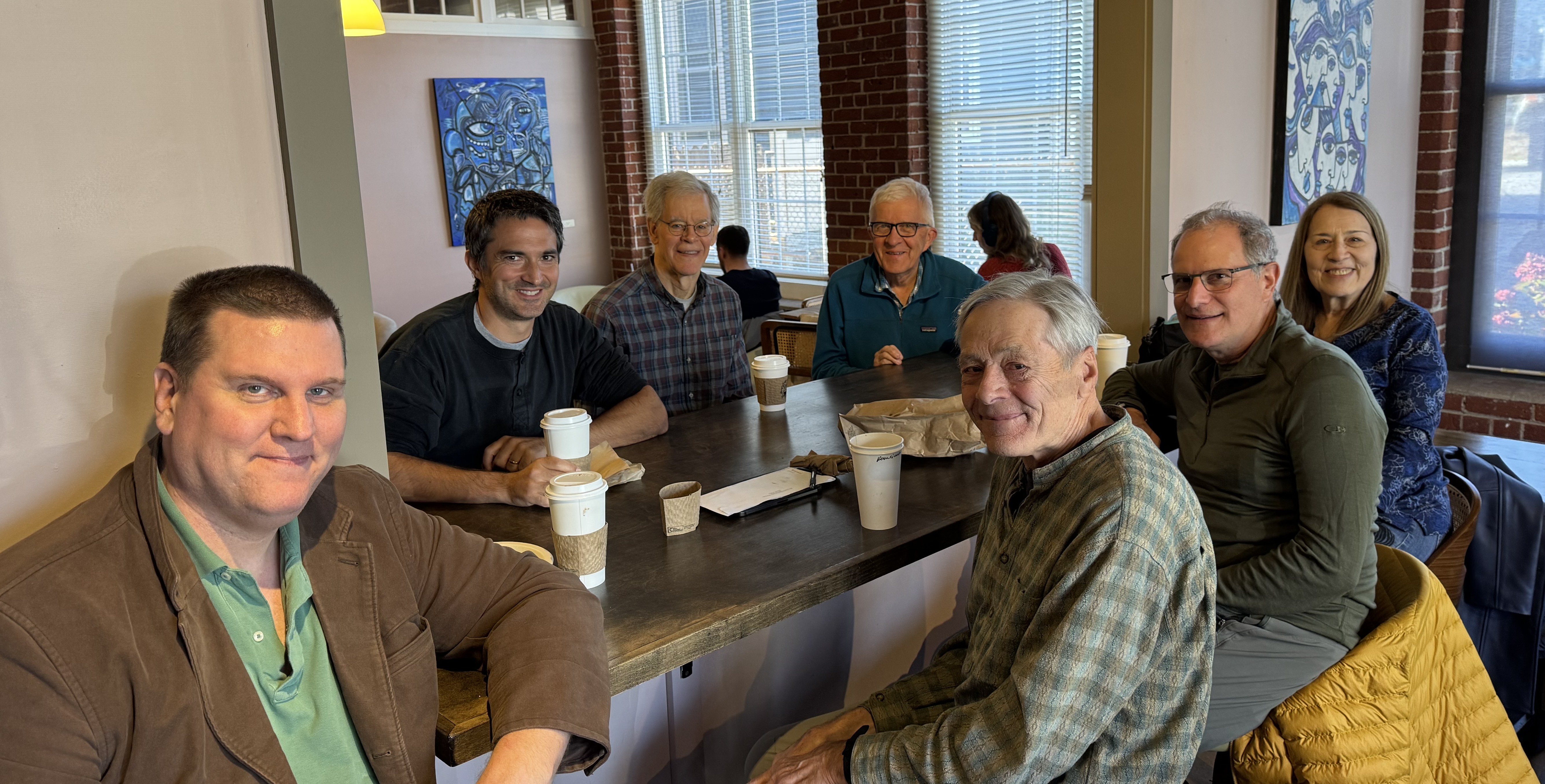 Group of heatsmart alliance members sitting in a coffee shop